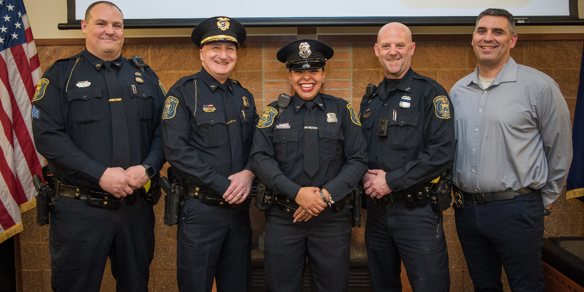 Police Officers standing with vehicles